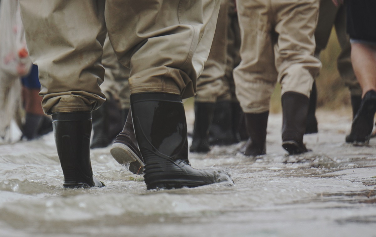 People in waterproof wellingtons as result of flood